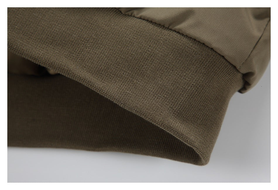 Close-up of a wide ribbed olive-brown cuff or hem band.