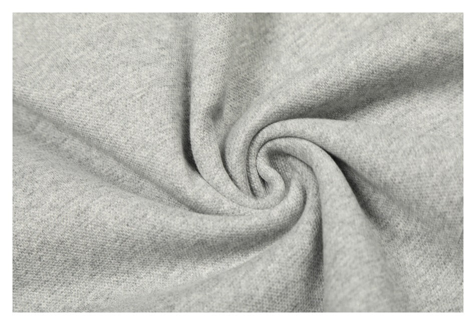 Close-up of the heather-gray sweatshirt fabric gathered into a swirl, showing its surface texture.