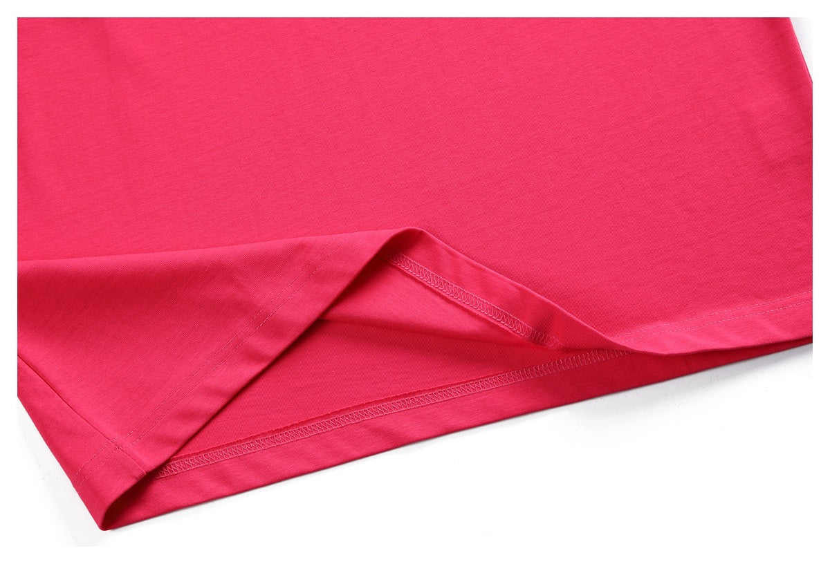Close-up of the bright pink T-shirt’s folded hem, showing the inner fabric and overlock stitching.