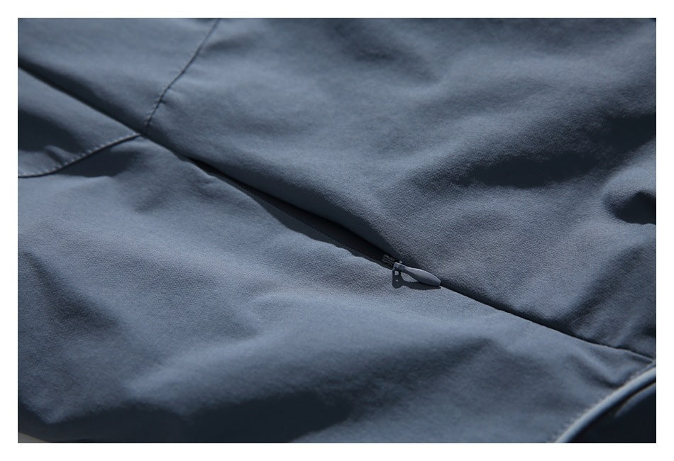 Close-up of a concealed zipper set into a seam on blue-gray fabric.