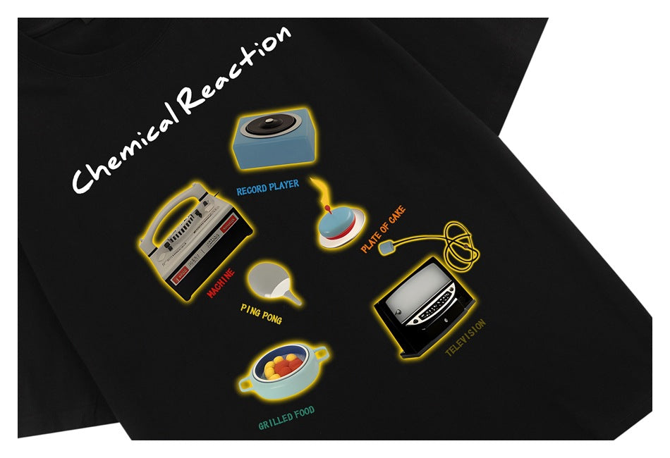 Close view of a black T-shirt with colorful retro object illustrations and the words “Chemical Reaction.”