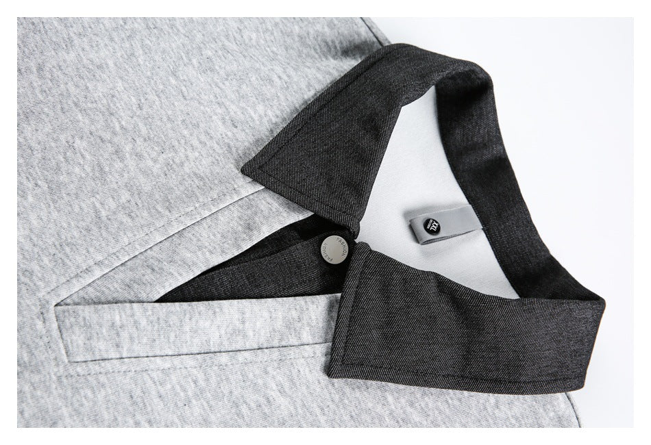 Close-up of a heather-gray pullover's dark collar, neckline opening, button, and inner size label.