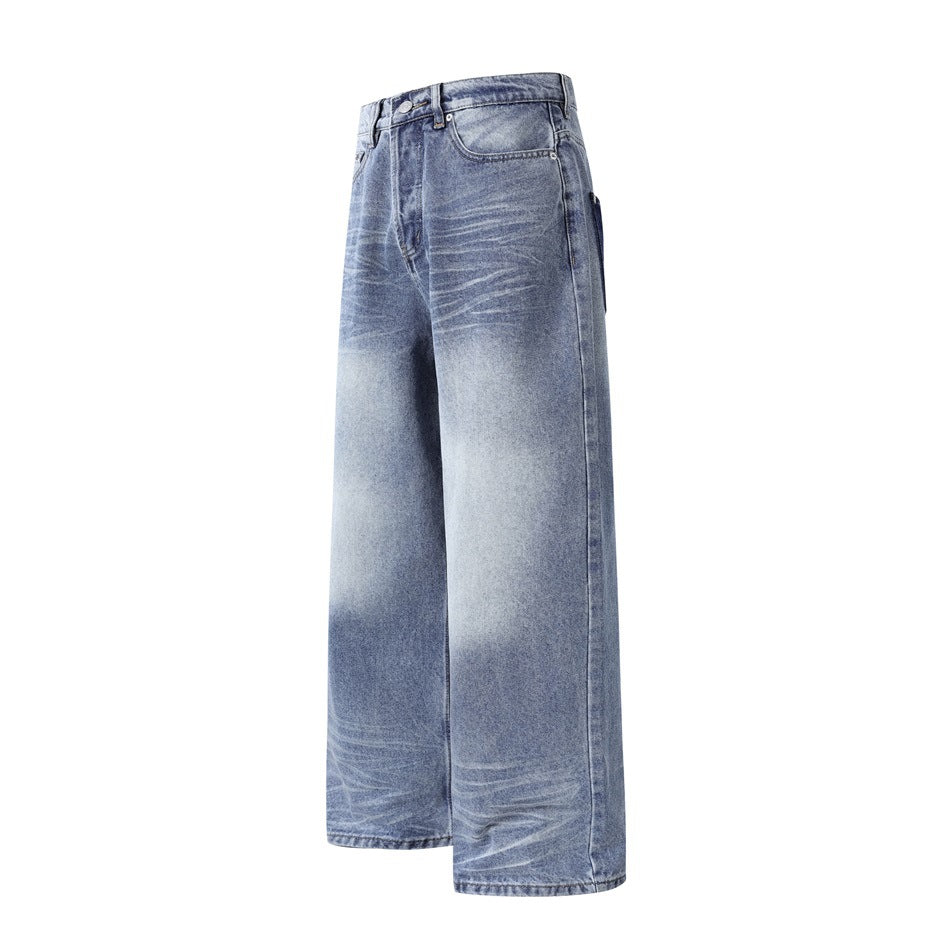 Angled front view of wide-leg blue jeans with faded whiskering, belt loops, and a classic five-pocket design.