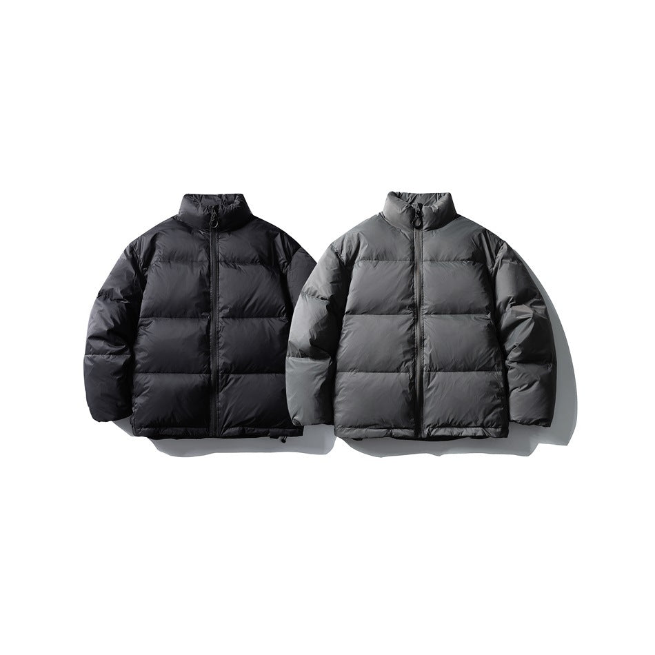 Two front-view puffer jackets side by side, one black and one charcoal gray, with high collars and front zippers.