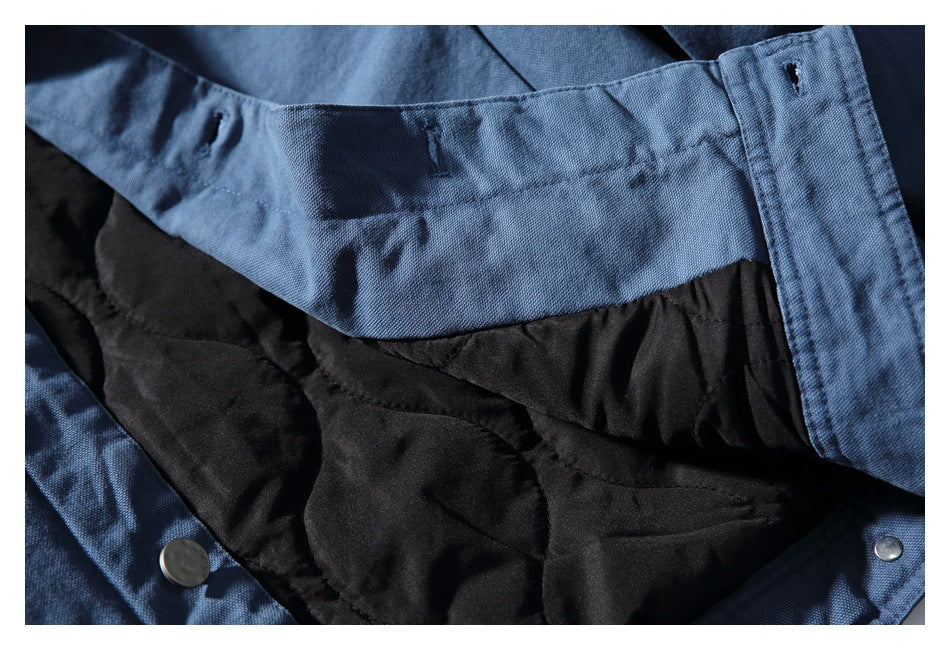Close-up of the blue jacket's black quilted lining and inner front placket.