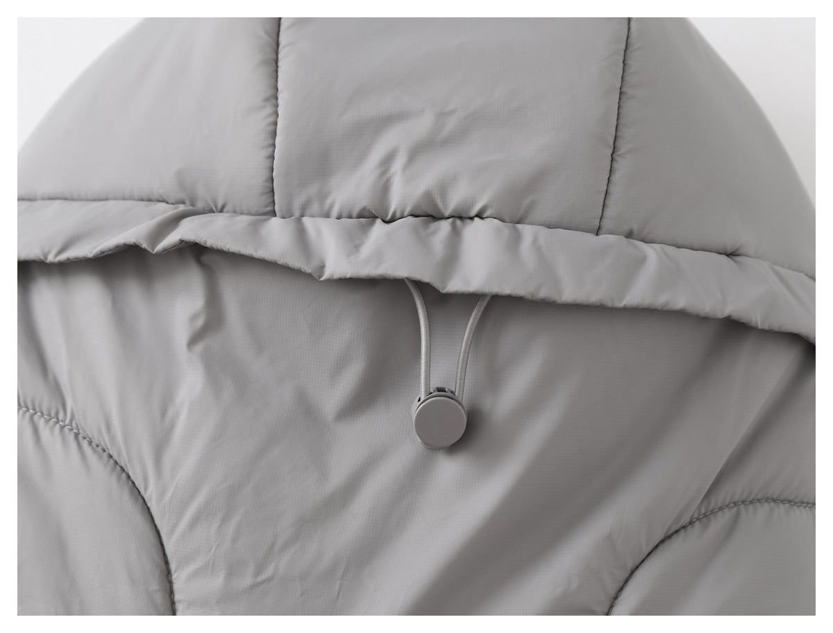 Close-up of a light gray padded garment with stitched panels and an adjustable drawcord toggle.