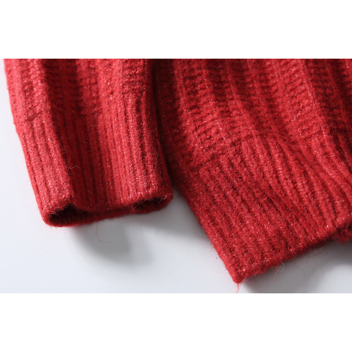 Close-up of the red sweater's ribbed sleeve cuff and hem.