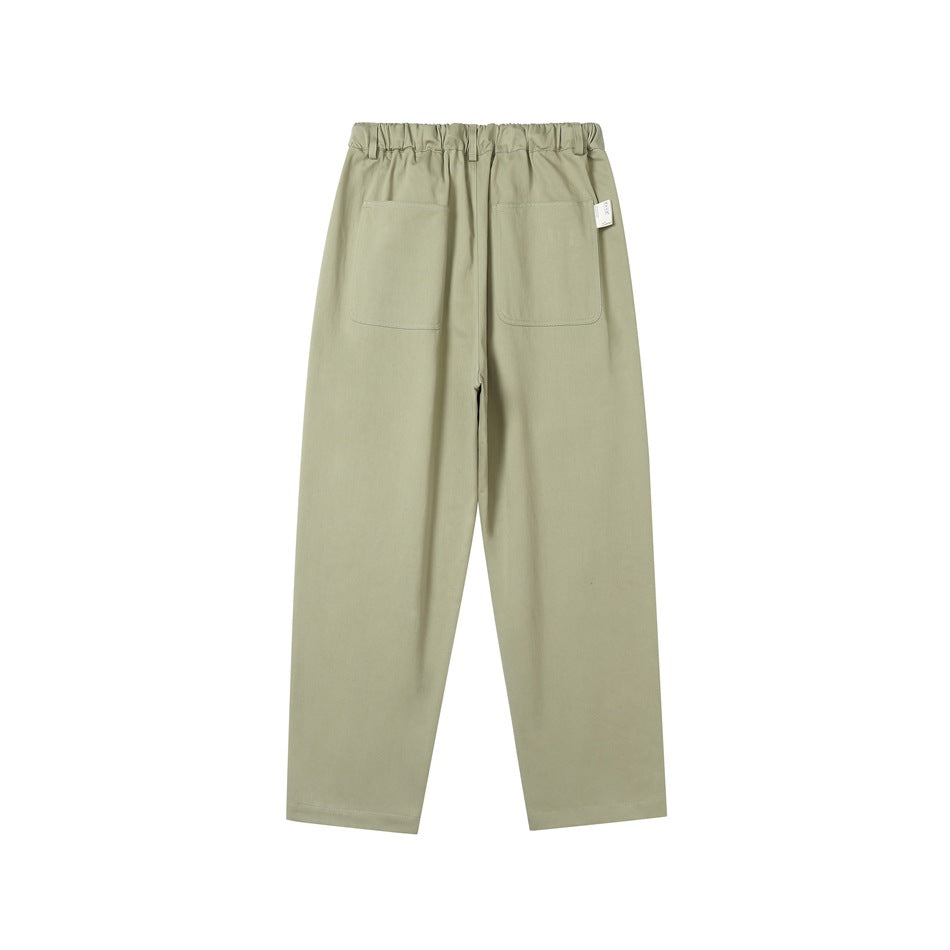 Light green wide-leg pants back view with two large patch pockets and elastic waistband