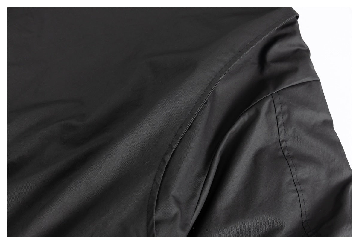 Close-up of curved stitched seams and a panel on a black garment.