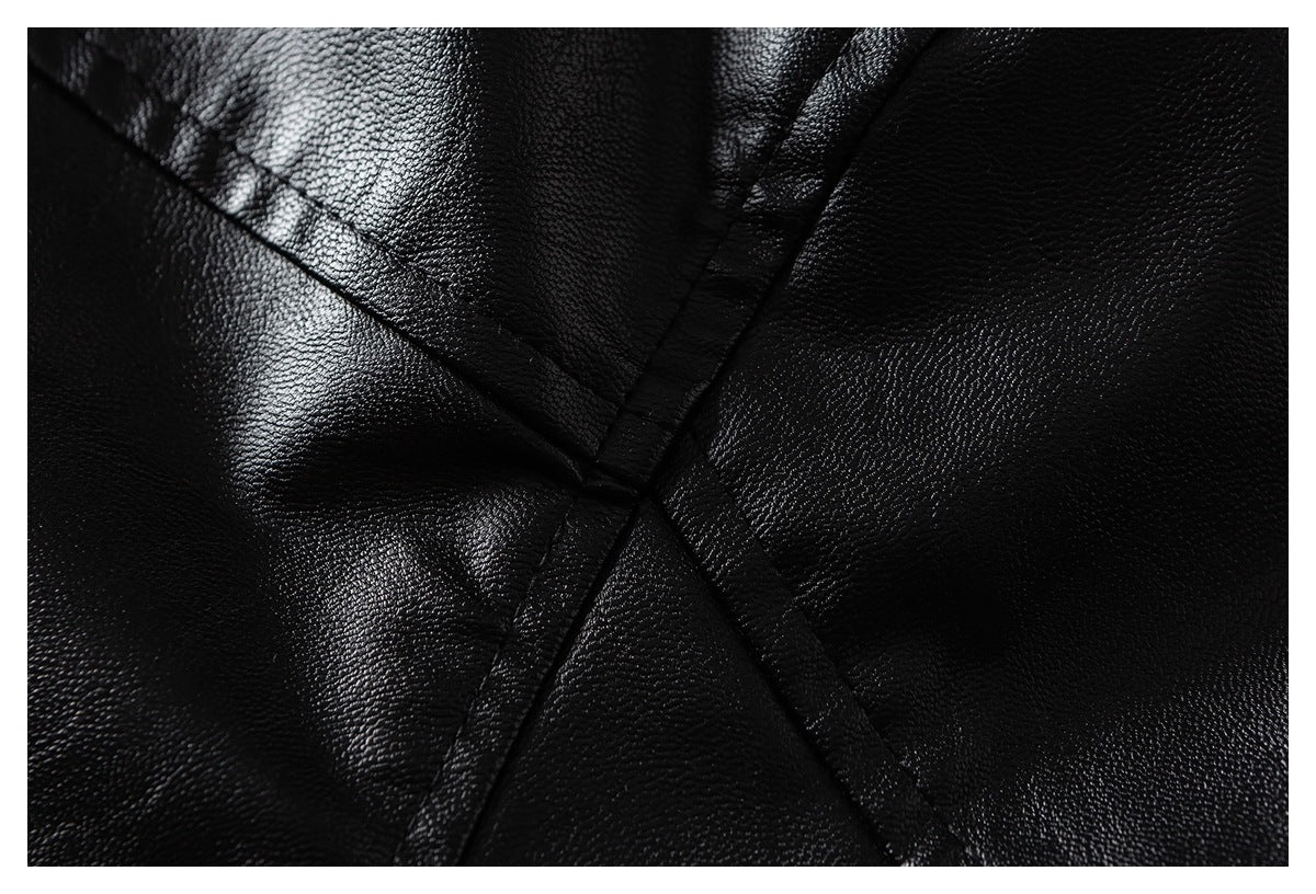 Close-up of intersecting seams on black textured garment material.