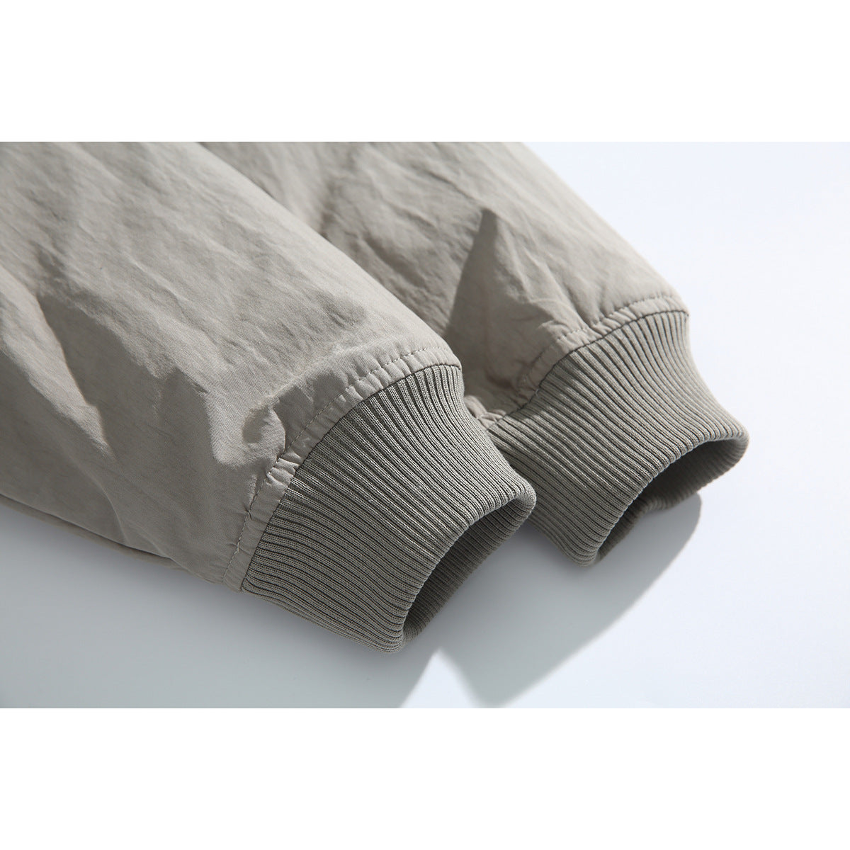 Close-up of the gray jacket's ribbed knit sleeve cuffs.