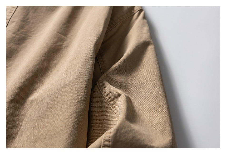 Close-up of the tan jacket's sleeve and underarm stitching.