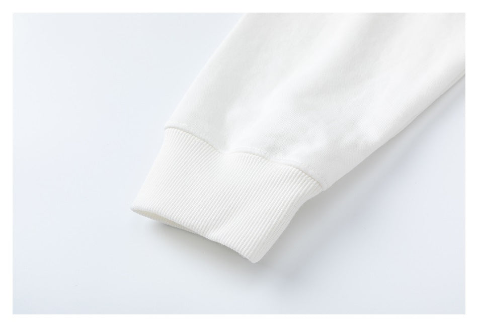 Close-up of a white sweatshirt sleeve ending in a wide ribbed cuff.