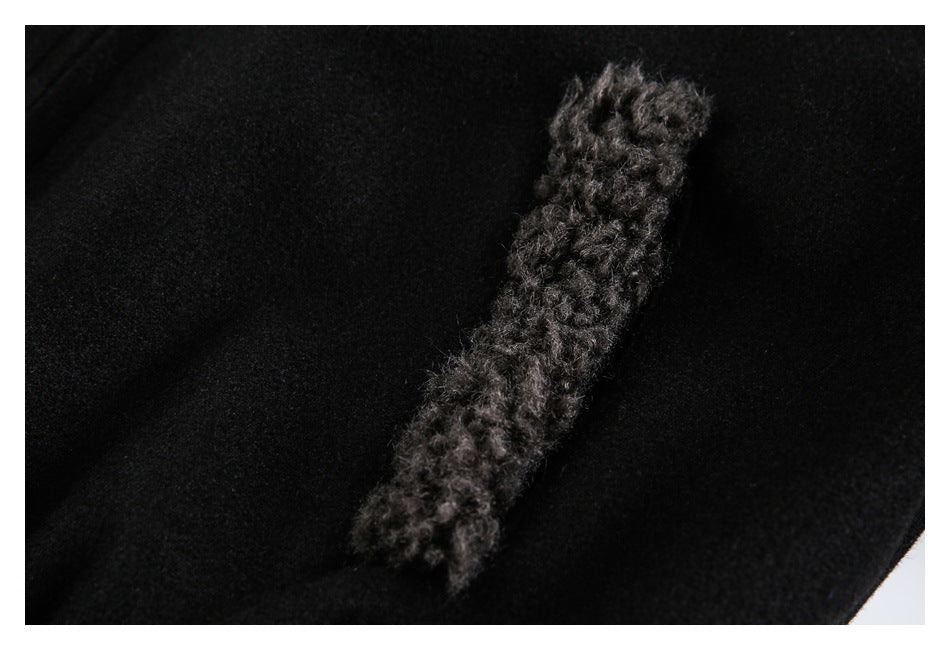Close-up of black fabric with a narrow strip of fuzzy charcoal trim.