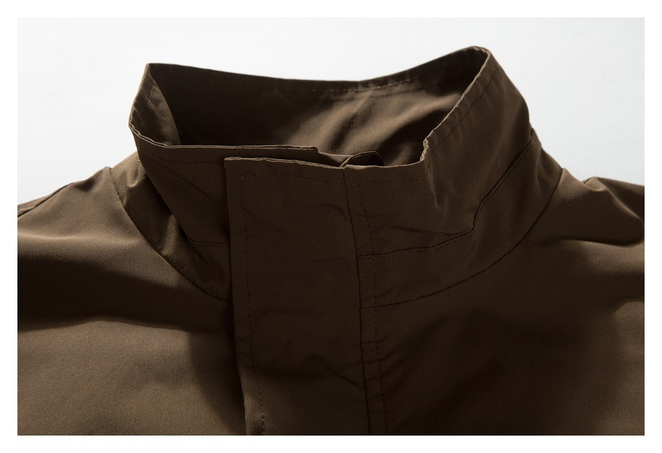 Close-up of a dark brown jacket’s tall stand collar and front placket.
