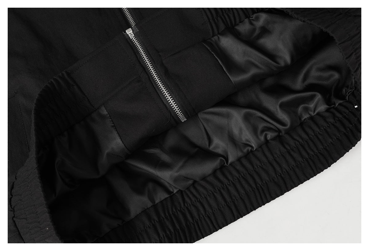 Inside view of the black garment, showing its lining, zipper, and gathered elastic edge.