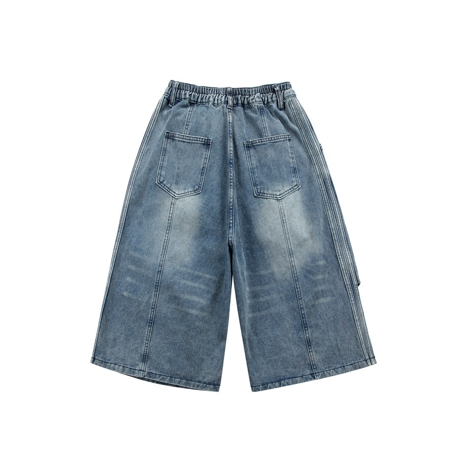 Back view of blue wide-leg denim shorts with an elasticated waistband and two patch pockets.