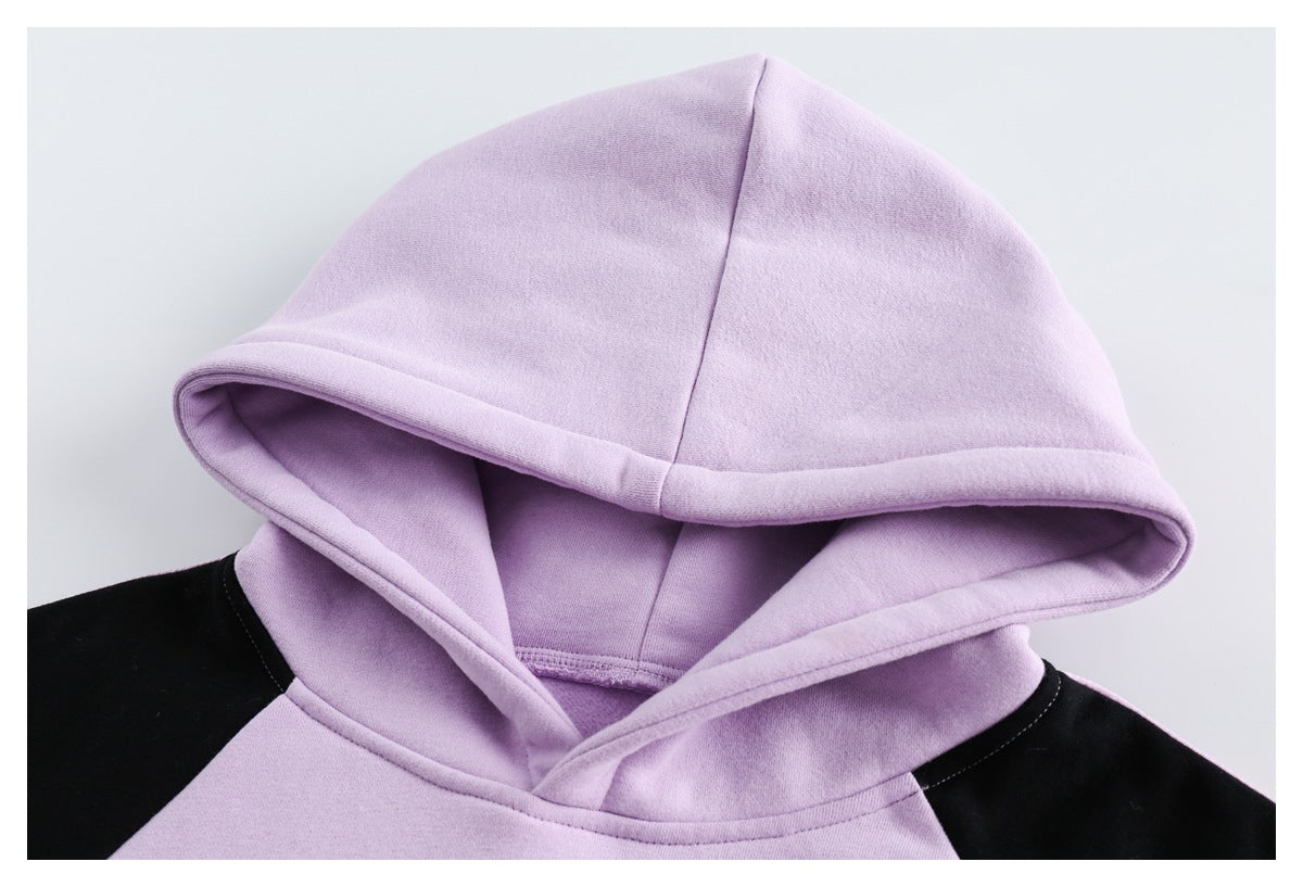 Close-up of the lavender hood and black shoulder panels on the hoodie.