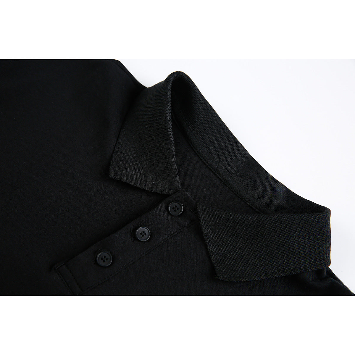 Close-up of a black polo-style collar and three-button placket.