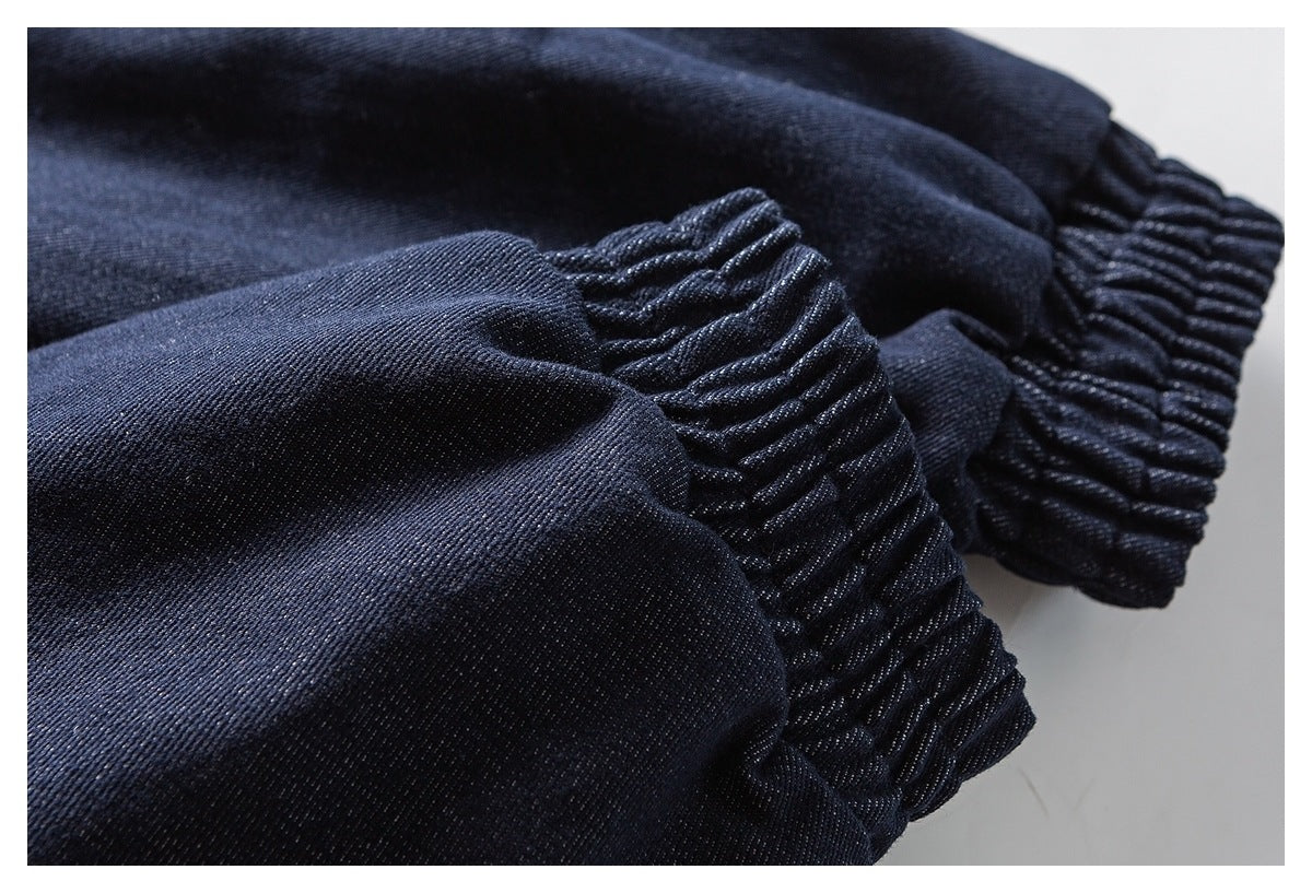 Close-up of gathered elastic cuffs on dark navy fabric.