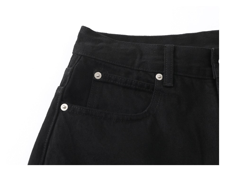 Close-up of the black pants' front pocket, coin pocket, waistband and belt loop.