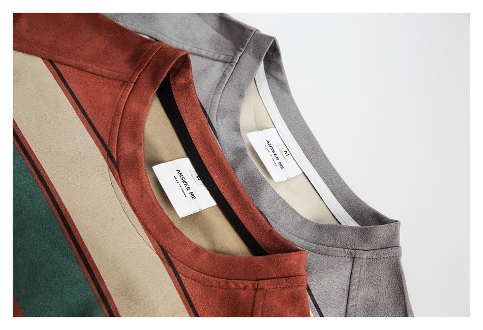 Close-up of the necklines and sewn-in labels of rust-red and gray striped T-shirts.