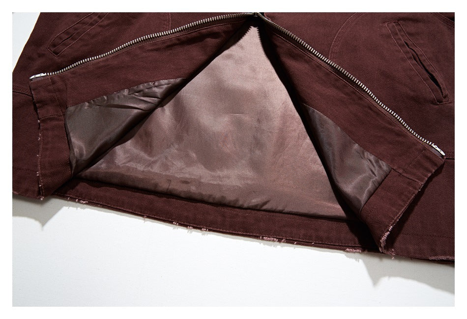Burgundy-brown garment opened to show its smooth inner lining, zipper, and pocket openings.