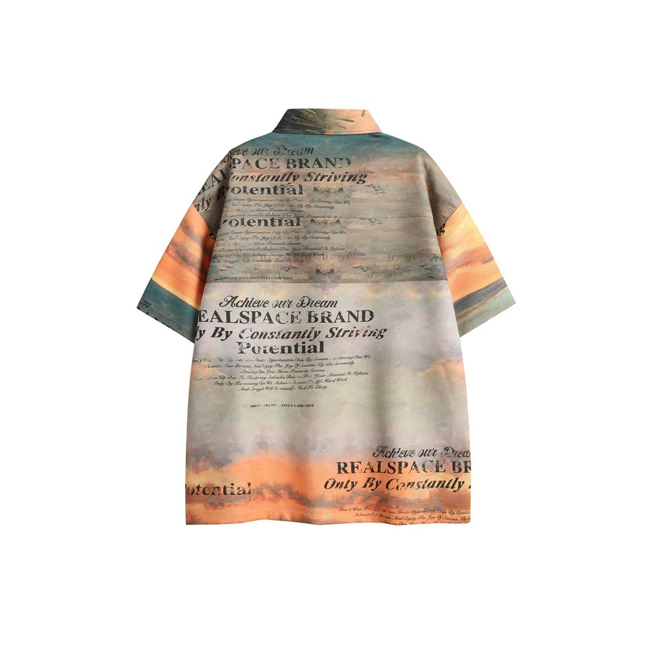 Back view of a short-sleeve shirt printed with a muted sunset landscape and large black English lettering.