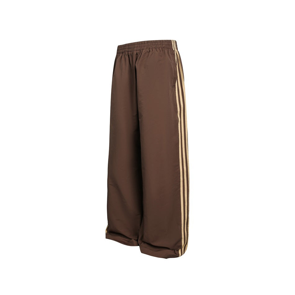 Brown wide-leg trousers shown from the front, with an elastic waist and three light-colored side stripes.
