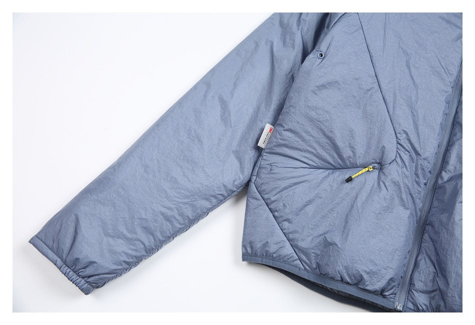 Close view of the blue-gray jacket sleeve, elastic cuff and angled pocket with a yellow cord pull.