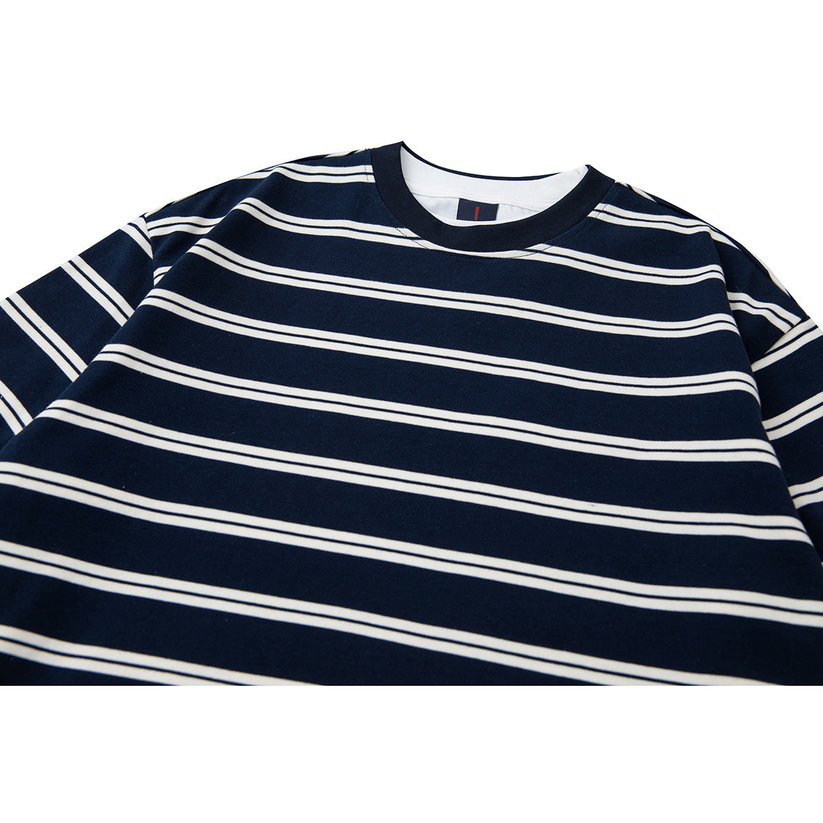 Close-up of a navy crew-neck shirt with thin white horizontal stripes and a dark ribbed collar.