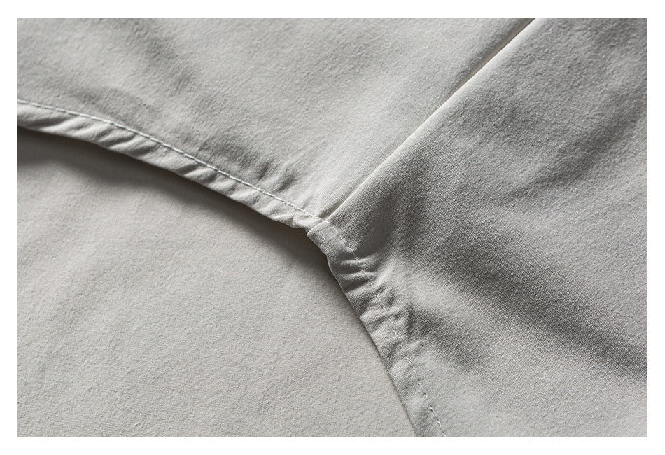 Close-up of a white shirt seam where the sleeve joins the body.