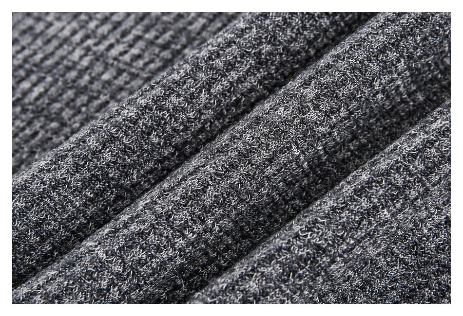 Close-up of dark gray heathered knit fabric with a textured, looped surface.