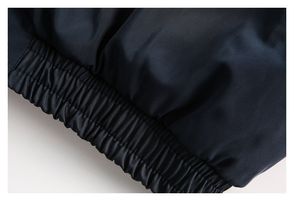 Close-up of a dark navy garment with a gathered elastic waistband.
