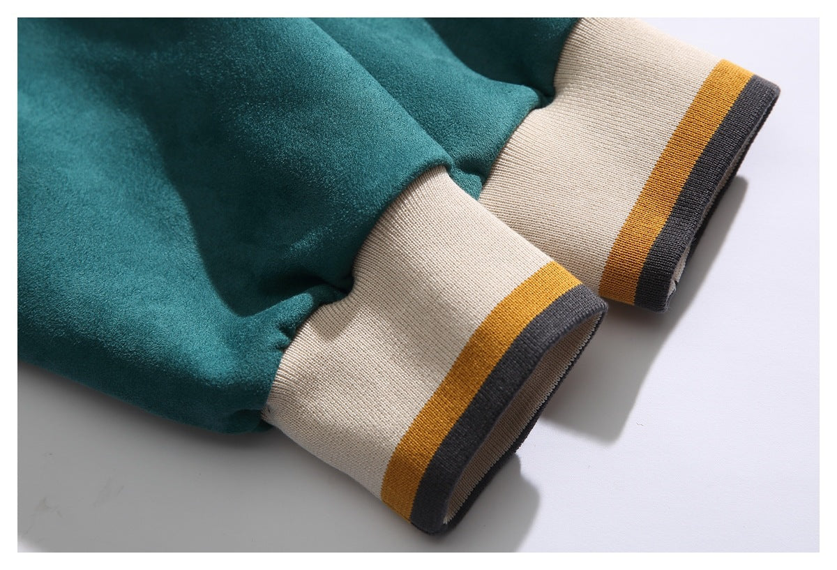Close-up of teal sleeves ending in cream ribbed cuffs with mustard and charcoal stripes.