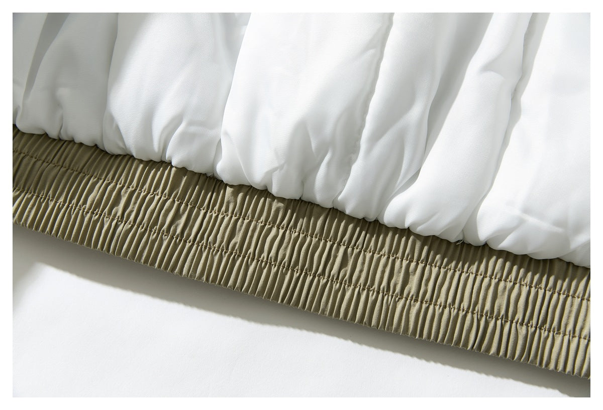 Close-up of the white lining gathered above the jacket's elasticated khaki hem.