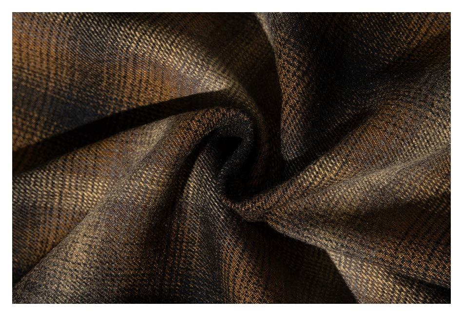 Close-up of brown and black woven fabric gathered into soft folds.