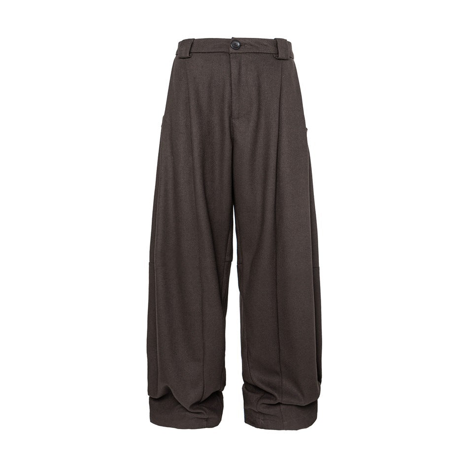 Brown wide-leg pleated trousers with button waistband and gathered cuffed hems, front view