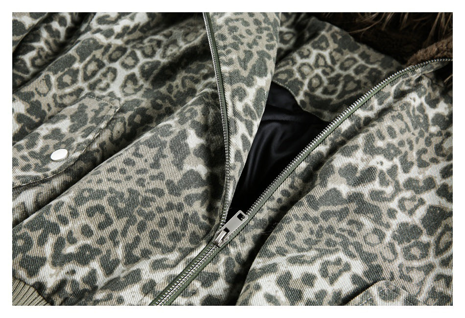 Close-up of the animal-print jacket's partially open metal zipper, black lining, and snap pocket.