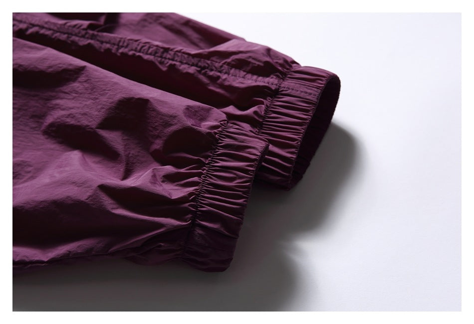Close-up of the gathered elastic cuff on a plum jacket sleeve.