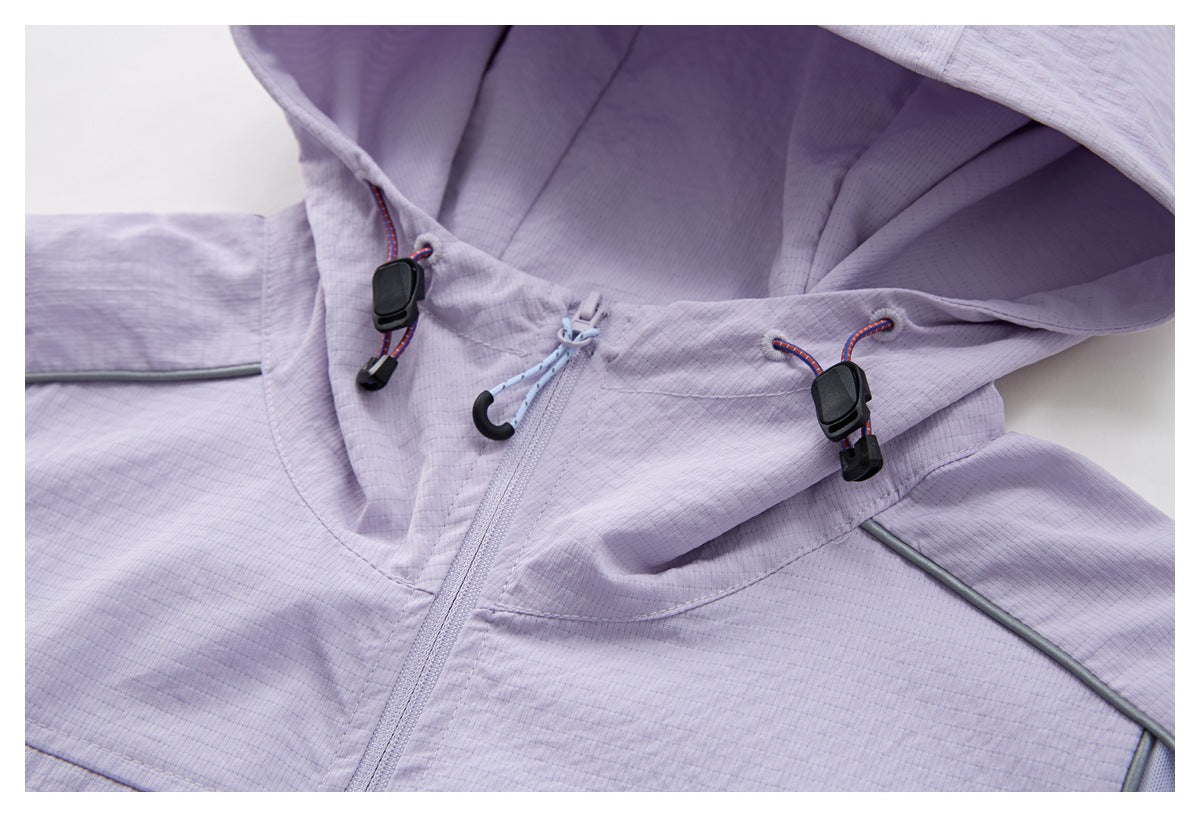 Close-up of a pale lavender hooded jacket with a front zipper, drawcords, and dark toggles.