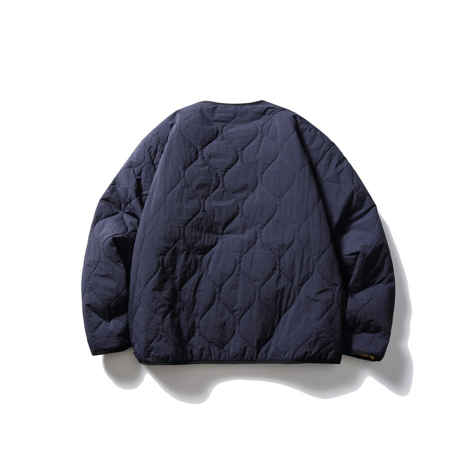 Back view of a navy quilted jacket laid flat, with long sleeves and wavy stitched panels.