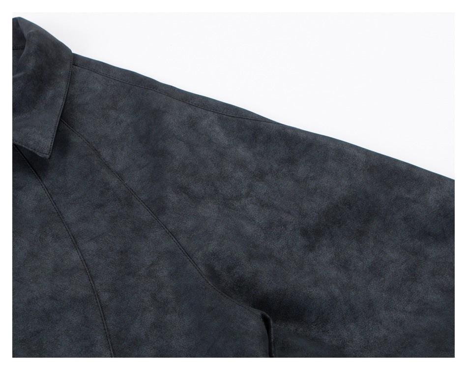 Close-up of the dark charcoal jacket sleeve and curved seam against a white background.