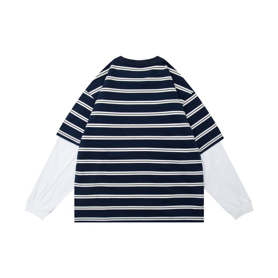 Back view of a navy-and-white striped layered shirt with short sleeves over long white sleeves.