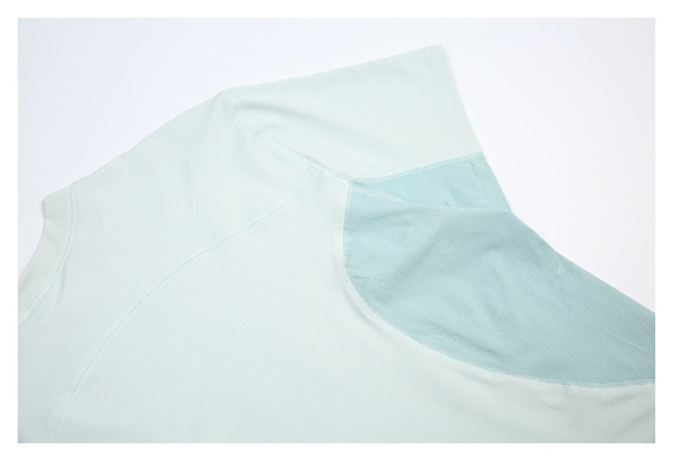 Close-up of a pale mint garment with curved seams and a darker perforated mesh panel.