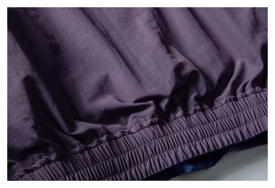 Close-up of the purple garment's gathered elastic waistband and fabric folds.