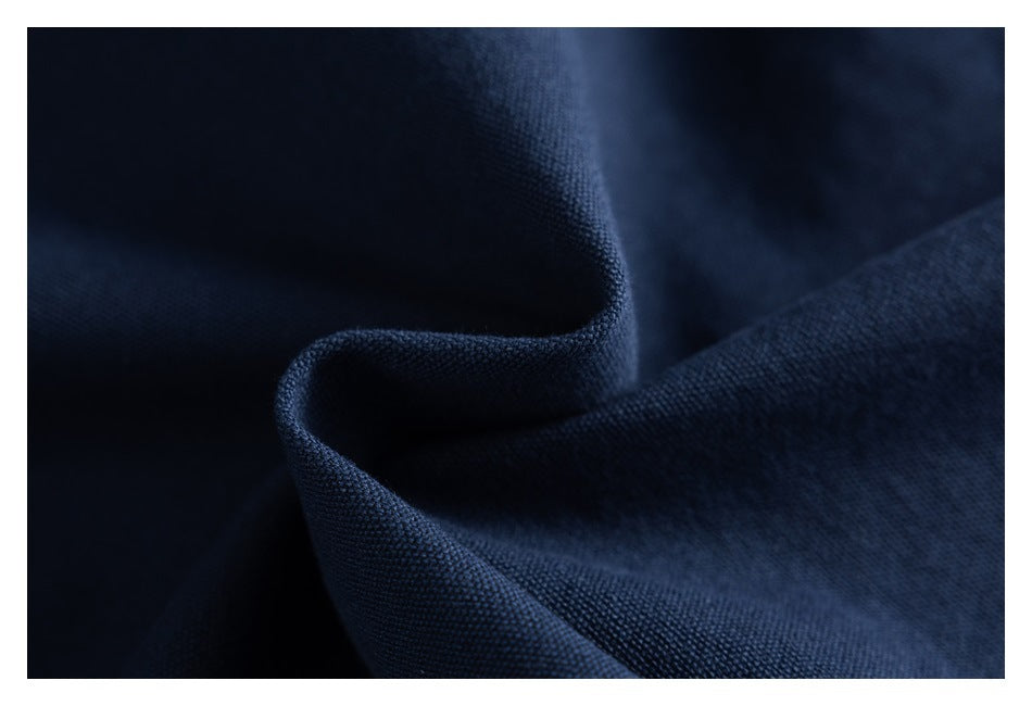 Macro view of textured navy fabric folded into soft ridges.