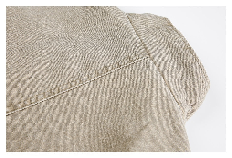 Close-up of a stitched seam on beige-tan garment fabric.