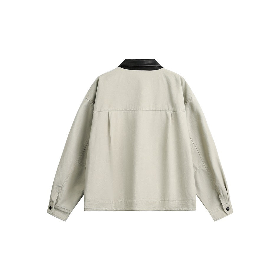 Back view of a light beige jacket with a black collar, long sleeves, and buttoned cuffs.
