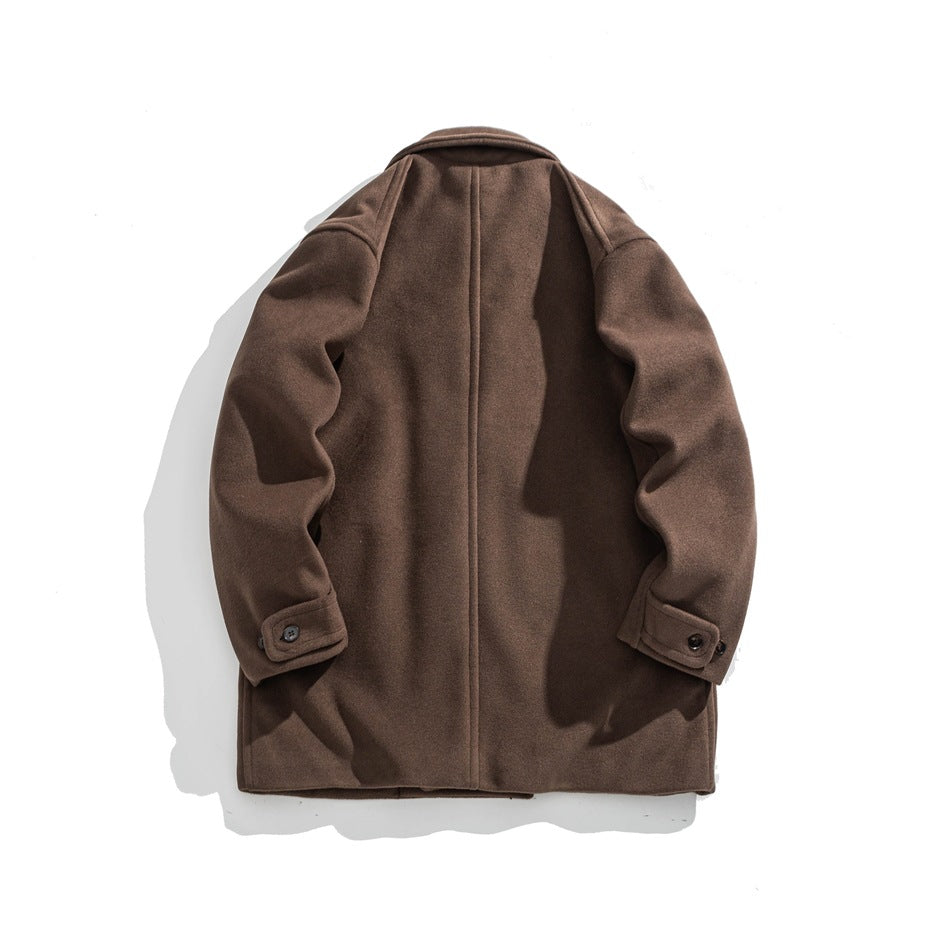 Back view of a brown coat laid flat, with a center seam and buttoned cuff tabs.